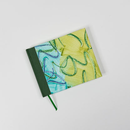 Chartreuse and turquoise paste paper cover with dark green book cloth spine and green ribbon marker, hand bound by Patti Paulus