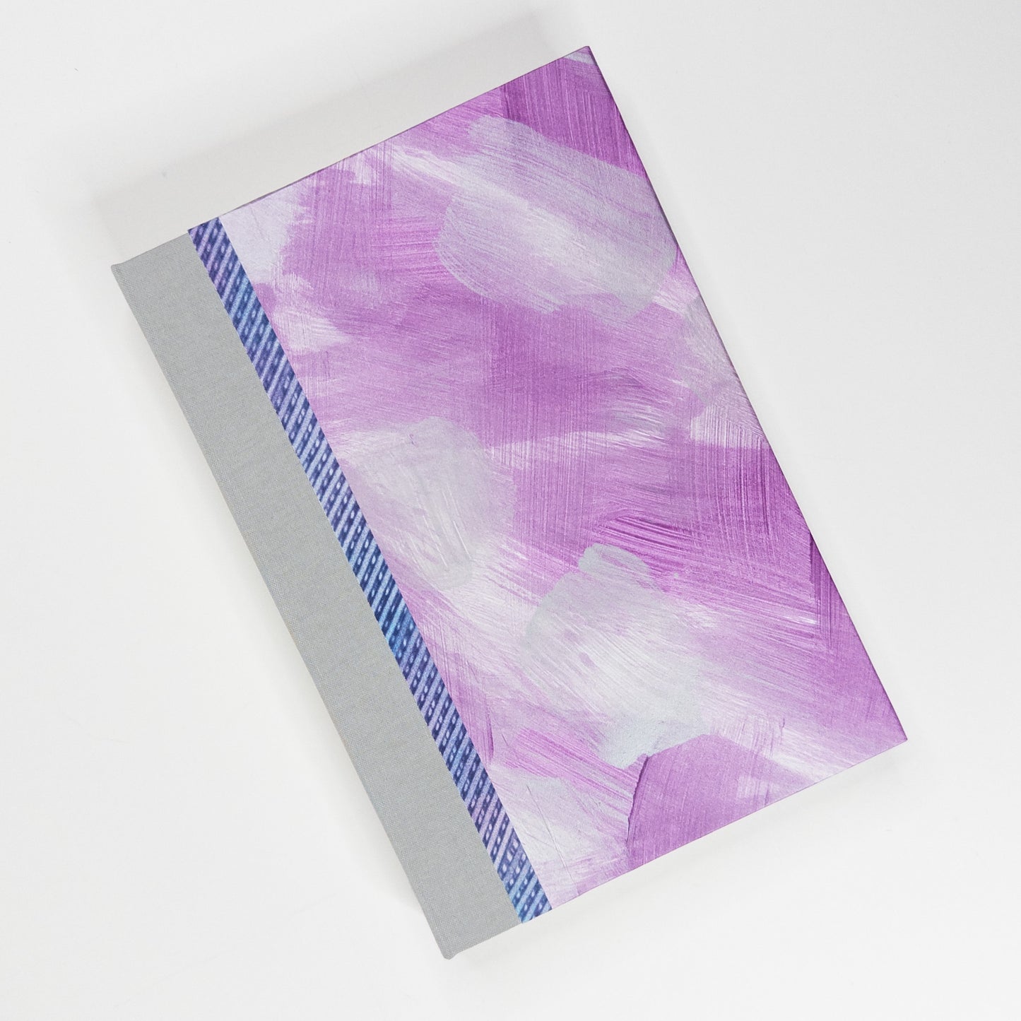 Pink, purple and silver paste paper cover with grey book cloth spine, hand bound by Patti Paulus