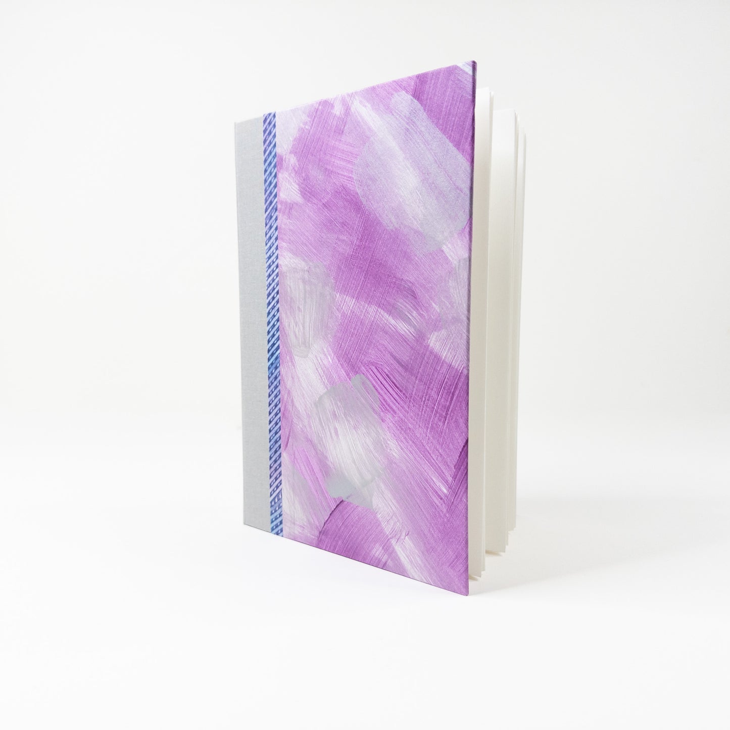 Open handmade book showing blank unruled pages and layflat binding