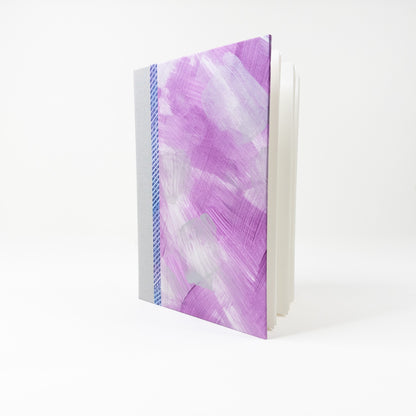 Open handmade book showing blank unruled pages and layflat binding