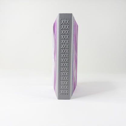 Grey linen spine crossed with a pale lattice of linen thread stitching