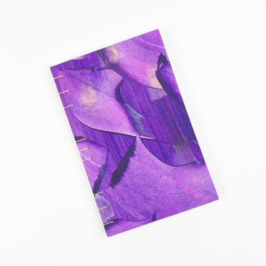 Purple and gold paste paper cover with exposed gold coptic stitching, hand bound by Patti Paulus
