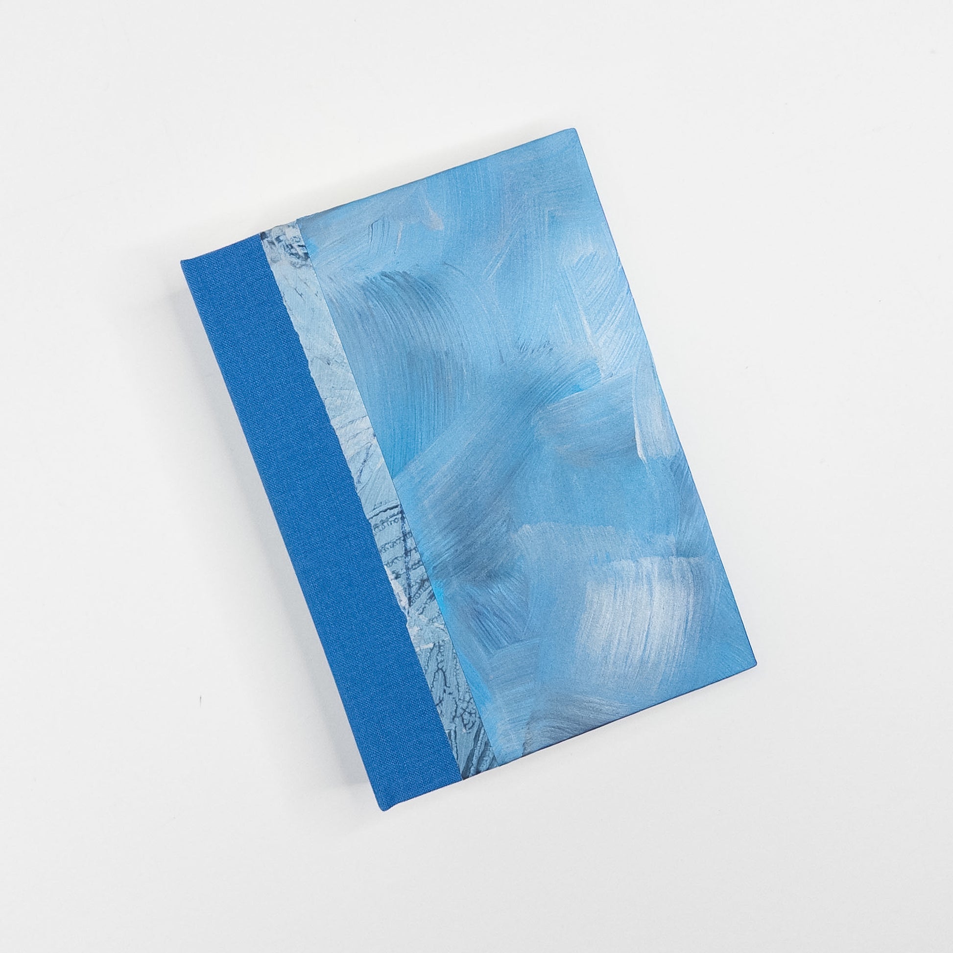 Blue, silver and grey paste paper cover with blue book cloth spine, hand bound by Patti Paulus